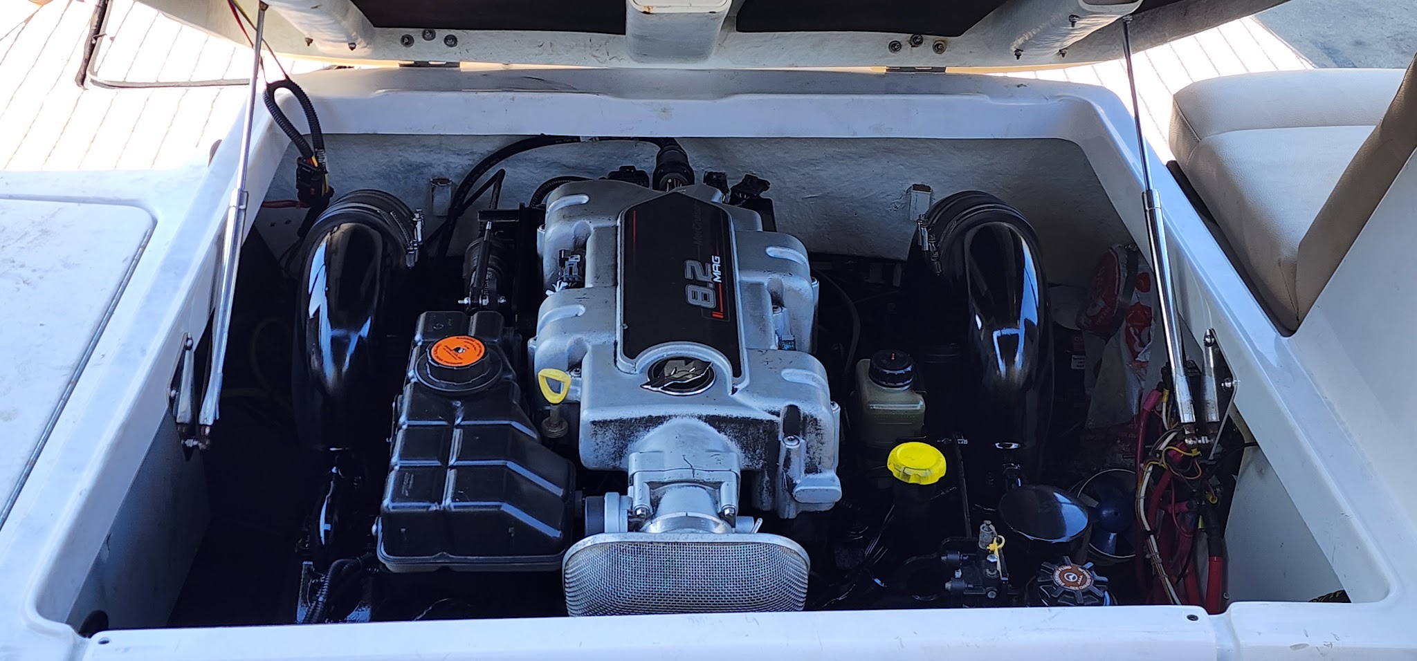 An inboard engine bay finished in white, everything clipped and tidy