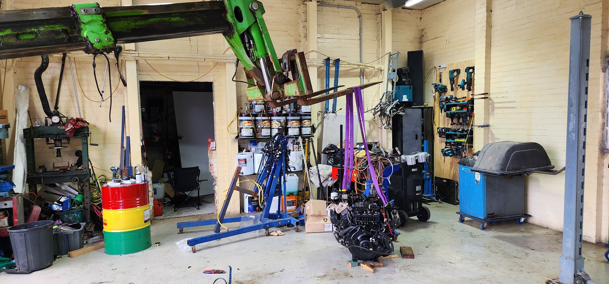 Inside our Central Coast workshop, with engine stands, a hoist and the bench